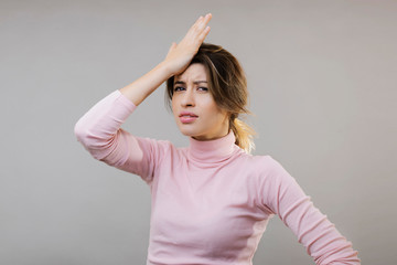 Fototapeta premium Attractive sad young woman with hand on head