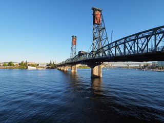 The Hawthorne Bridge over the Willamette River in Portland, Oregon, on a clear, cloudless autumn afternoon.