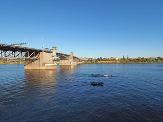 The Morrison Bridge over the Willamette River in Portland, Oregon, on a clear and cloudless autumn afternoon.