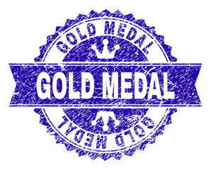GOLD MEDAL rosette stamp seal watermark with grunge effect. Designed with round rosette, ribbon and small crowns. Blue vector rubber watermark of GOLD MEDAL label with corroded texture.