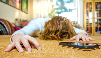 a woman is ill and reaches for his smartphone