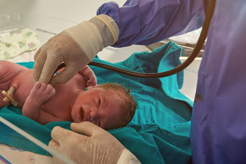 Checking health of newborn baby