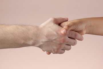 Man shaking woman's hand