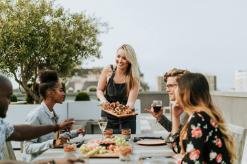 Woman serving vegan barbecue to her friends