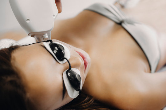 Close up photo of a woman that is doing laser epilation on face