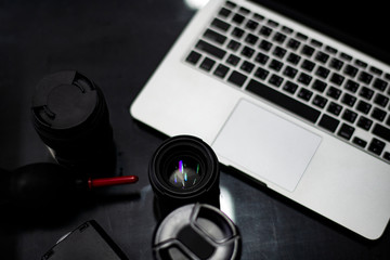 Closeup of a camera lens and a laptop