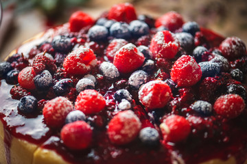 Closeup of a cheesecake covered with mixed berries