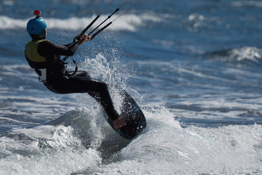 A kite surfer rides the waves, fun in the ocean extreme sport