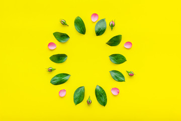 Stylish pattern with flowers. Roses, buds, petals on yellow background top view mockup