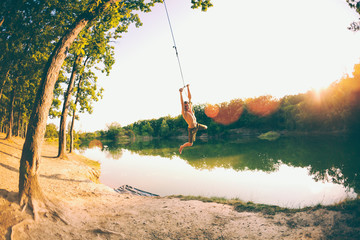 A man is riding a swing.