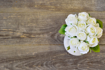 Bouquet of white roses on a wooden vintage background. Element of a greeting holiday card.
