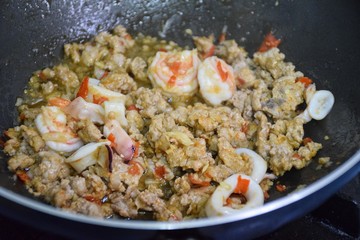 Stir Fried Pork, shrimp and squid with Holy Basil (Pad ka prao or Phat kaphrao) on Pan.