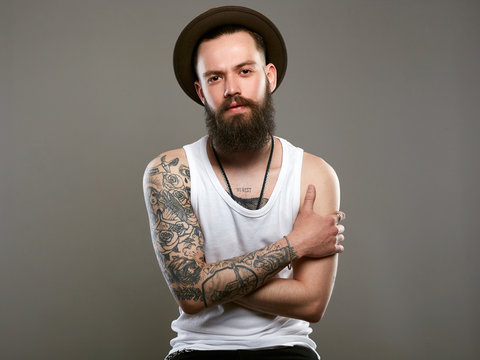 Tattooed handsome Bearded Man in Hat