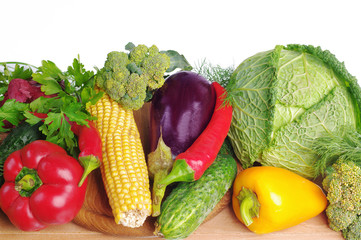 Vegetables on a white background. Cabbage, cucumbers, tomatoes, peppers, corn, eggplant, onions, carrots