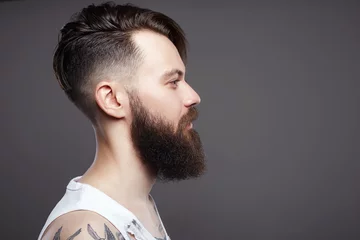 Fotobehang bearded hipster. Boy with stylish haircut and tattoo © eugenepartyzan