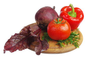 Tomato, beet, pepper on the kitchen board