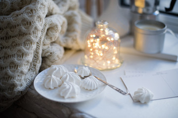 Cozy winter interior styling and decor, warm string lights in bell jar