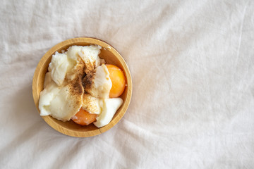 Soft boiled eggs with pepper and salt in wooden cup.