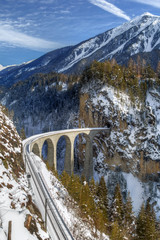 The famous Landwasser Viaduct, which ia a wonder of Swiss mountain railway engineering in 1901 and a unesco heritage since 2008.