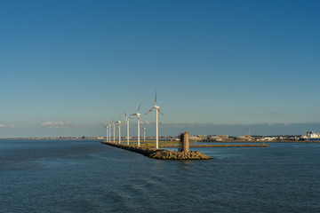 Wind turbines near a harbor in the industrial area of ​​Zeebrugge - 244460391