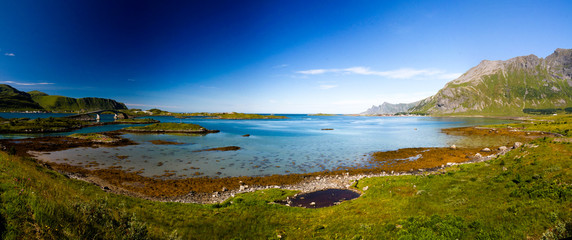 Fototapeta premium Landscape panoramic view to Fredvang bridge, Torvoya and buoya islands and Hovdanvika bay, Lofoten, Norway