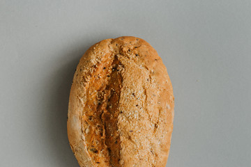 Whole loaf bread crispy gray background top view