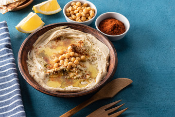 Classic Hummus with chickpeas, paprika, olive oil and oriental spices. Mediterranean popular snack of chickpeas and tahini pasta.