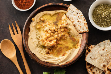 Classic Hummus with chickpeas, paprika, olive oil and oriental spices. Mediterranean popular snack of chickpeas and tahini pasta.