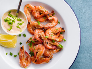 Shrimp glazed in soy sauce with green onion and lemon.