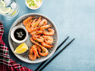 Shrimp glazed in soy sauce with green onion and lemon.