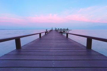 Fototapeta na wymiar Beautiful jetty walkway on the sea in twilight time.