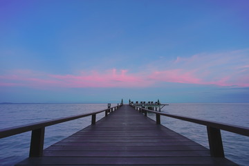 Fototapeta na wymiar Beautiful jetty walkway on the sea in twilight time.