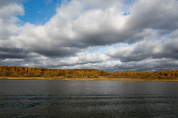 Autumn landscape - lake, clouds and forest