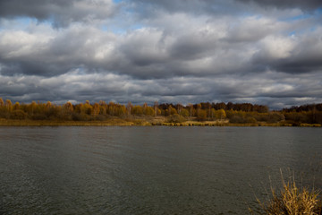 Autumn landscape - lake, clouds and forest