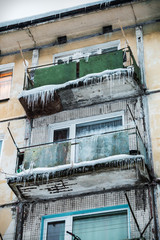 roofs of houses and balconies in huge hanging icicles. Winter is harsh in the city