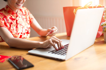 Chinese new year concept , Asian woman in chinese dress traditional cheongsam with gesture of congratulation
