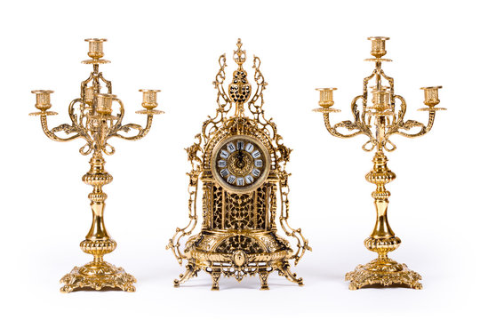 Vintage gold watch with candelabra on white background