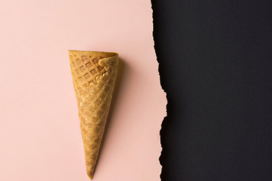 Empty waffle ice cream cone on dutone peachy pink black paper background with torn edge. Styled image mockup flyer poster template for cafe menu collage elements artwork text lettering. Funky