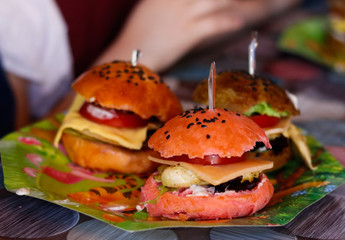 Ingredients for making a sandwich on a multicolored table in a cafe room.