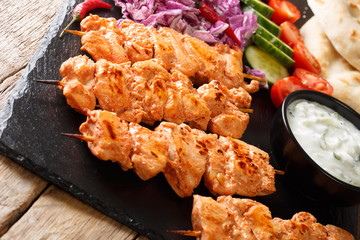 Lebanese Shish Taouk (Tawook)with fresh vegetables, yogurt sauce and pizza close-up. horizontal