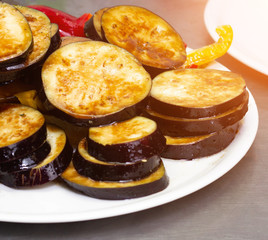 Grilled steamed and roasted vegetables eggplant and red pepper on a plate, close-up
