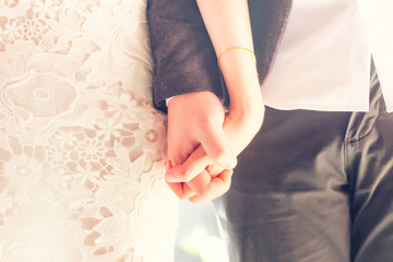 married couple holding hands, wedding day ceremony