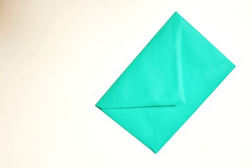 Closed vintage green envelope on white background with copy space