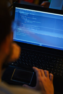 Laptop screen with lines of code. Programmer writes an application in the programming language. 