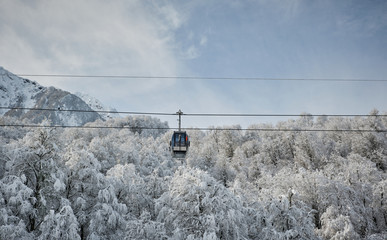 Fototapeta premium Cable cars on a background of mountains