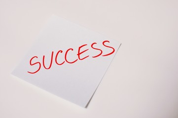 The word success written by hand and put on the white table with copy text