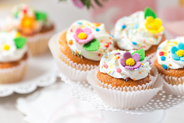 Fototapeta na wymiar Easter cupcakes with white cream and sugar flowers