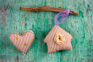 cute stripped soft toy heart and house  on a vintage wall