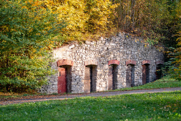 old stone wall with doors in the park