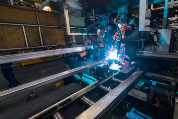 Fototapeta na wymiar Welding robot, the process of welding a metal profile.